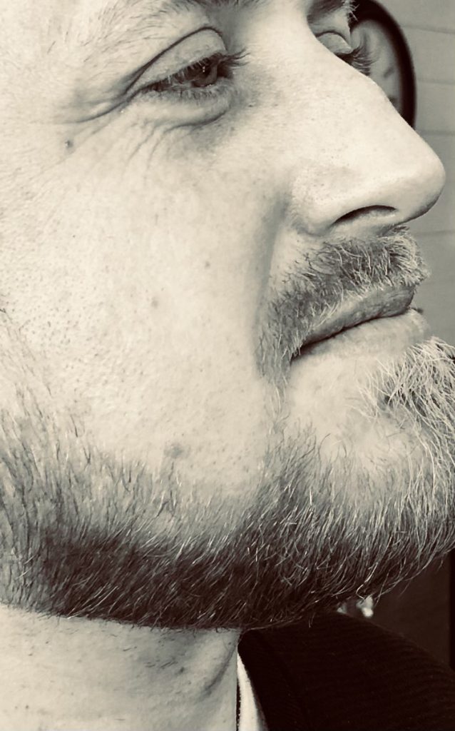 A close up of the face and beard of a man